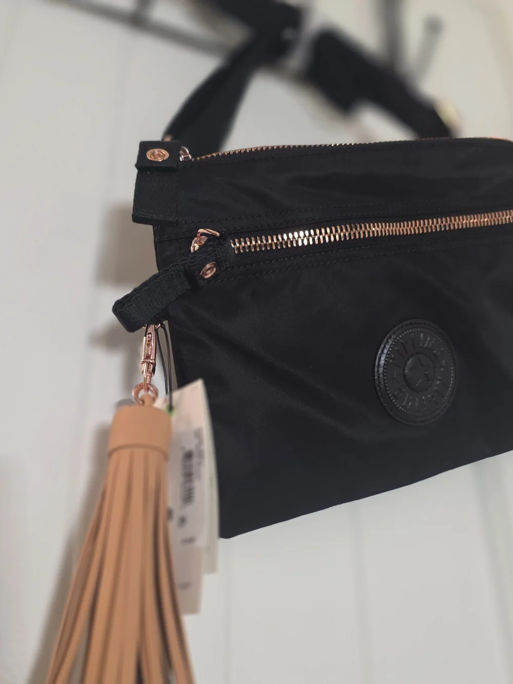 Kipling Black Crossbody with Rose Gold Hardware and Tan Tassel